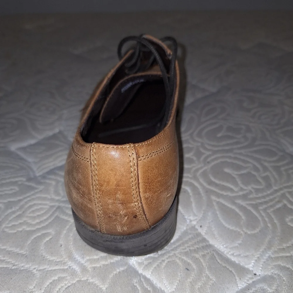 A pair of Cole Haan Oxfords in a men's size 12M. Pre-loved in good condition.